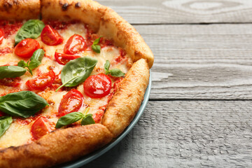 Delicious Margherita pizza on gray table, closeup. Space for text