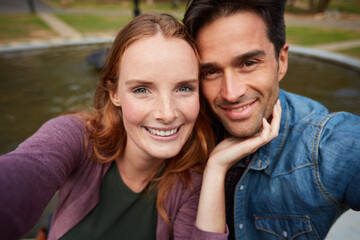 Selfie, happy couple and hug in nature with love, fun and bonding on travel, date or anniversary outdoor. Support, portrait and people embrace in park with trust, care and commitment in Canada