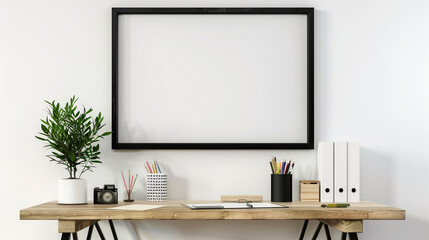 Black frame on a white wall, above a small wooden desk with stylish stationery and a potted plant.