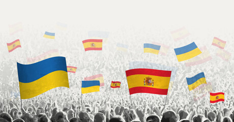 People waving flag of Spain and Ukraine, symbolizing Spain solidarity for Ukraine.