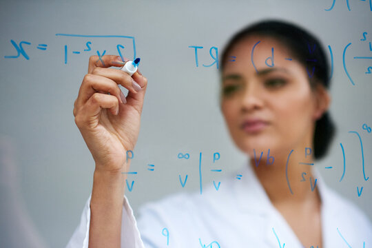 Hand, problem solving and science on glass with woman in studio on gray background for equation or formula. Innovation, research and writing with woman scientist in laboratory for breakthrough