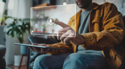 man using his graphics tablet about to play a video, represented by a hologram of a video player - concept of cyberspace, watching movies, streaming, an internet video, virtual reality