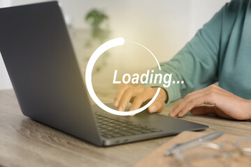 Loading. Woman working on laptop at table indoors, closeup