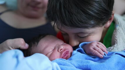 Older sibling lovingly cuddles newborn baby in a heartwarming moment of affection and connection, with mother close by, emphasizing family love and the precious bond between siblings