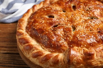 Tasty homemade pie and ingredients on wooden table, closeup