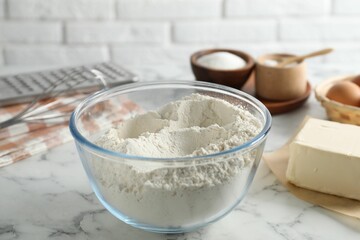 Making shortcrust pastry. Flour in bowl and butter on white marble table