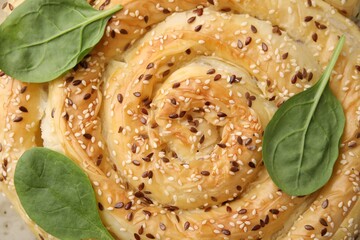 Delicious puff pastry with spinach as background, closeup