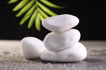 White spa stones with water drops on grey background