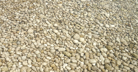 CLOSE UP: Detailed view of white pebbles scattered under crystal clear sea water. A peaceful and...
