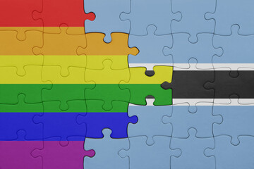 Fototapeta premium puzzle with the colourful national flag of botswana and rainbow gay pride flag .