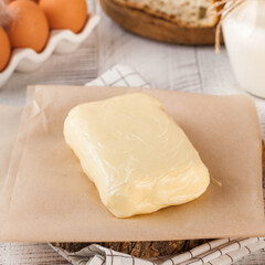 Freshly crafted creamy butter slab on parchment. Dairy