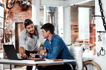 Business people, laptop and teamwork in workshop for startup collaboration, brainstorming and training. Worker or craftsman with computer talking, planning and research of steel industry and trade