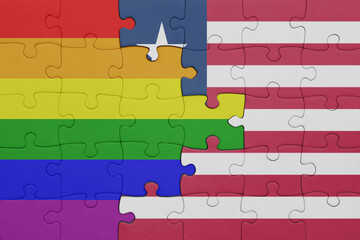 puzzle with the colourful national flag of liberia and rainbow gay pride flag .