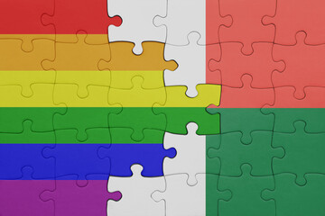 puzzle with the colourful national flag of madagascar and rainbow gay pride flag .