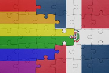 puzzle with the colourful national flag of dominican republic and rainbow gay pride flag .