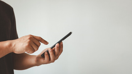 Young man hand holding smartphone for calls, social media, mobile application online isolated in white background, searching or social networks concept, hipster person typing an SMS, texting message.