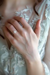 Close up of a bride wearing a diamond engagement ring, yellow gold band, simple design