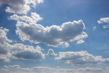 Cumulus clouds in the blue sky.