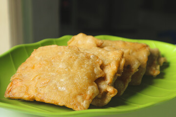 Deep fried tempeh or Tempe Mendoan is Indonesian traditional food made from tempeh covered in flour batter.