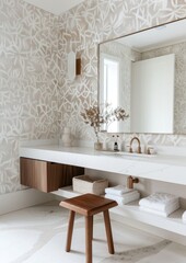 A simple modern bathroom with an oversized white marble vanity and wall mirrors featuring natural stone floors,