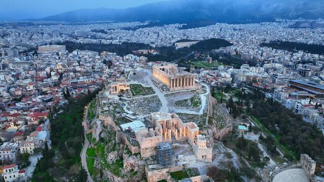 drone view of Acropolis with evening illumination, flying around ancient Acropolis in Athens, Greece at night