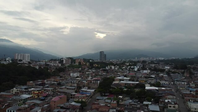 aerial video taken with a drone of a panoramic view of the city on a cloudy day where the horizon is lost between clouds and mountains