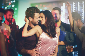 Couple, dance and love in club at night on date with romance in marriage or relationship. People,...