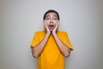 Portrait of young Asian man posing on white background
