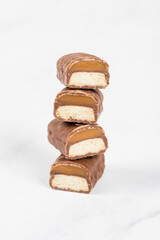 Cookie bar with caramel in chocolate glaze. In the section. White background. Close-up