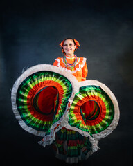 Mexican woman with escaramusa costume jalisco mexico orange color A woman in a colorful dress is posing for a picture