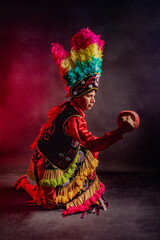 Matlachines Dancer from Coahuila Mexico A man wearing a colorful costume and holding a drum