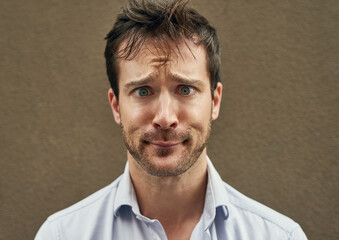 Man, cross eye or funny face on isolated background in silly, goofy or comedy on mockup or wall backdrop. Comic, emoji or happy comedian guy in quirky pose, joke style trend or facial expression