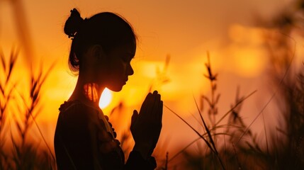 Silhouette of a woman paying respects and praying A symbol of gratitude to the Lord.