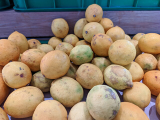 A vibrant stack of bright yellow lemons graces the table, their round shapes adding a pop of color...