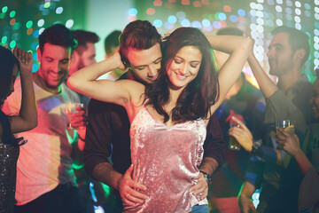 Couple, love and dance in club at night on date with romance in marriage or relationship. People,...