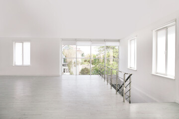 Empty room with windows and laminated floor