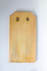A wooden cutting board that is dirty from frequent use, isolated on a white background