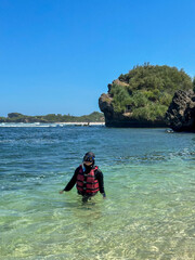 indonesian young woman in hijab swimming snorkeling enjoying holiday at the beach