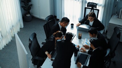 Top view businesspeople placed tablet at table and planning strategy while diverse team discuss...