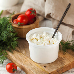 Fresh cottage cheese in a plastic ja for a healthy and nutritious breakfast.