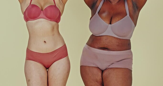 Dance, body and women in underwear for inclusion in studio isolated on a green background. Positivity, friends in lingerie and diversity, beauty of different plus size people together and acceptance