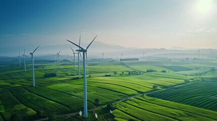 A large field of wind turbines with a clear blue sky in the background