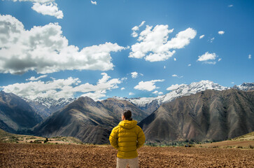 latin hiker observing the mountains and the andes mountain range.