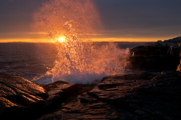 Waves Crashing on Shore Backlit by Sunshine