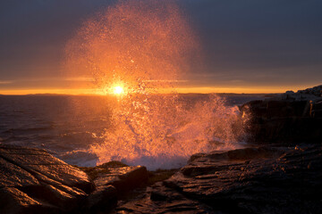 Waves Crashing on Shore Backlit by Sunshine