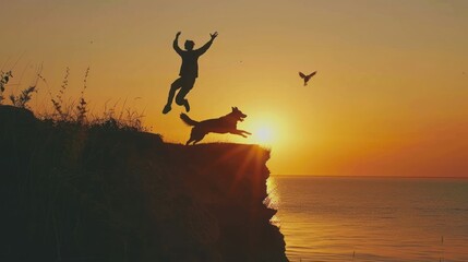 Silhouette dog and young man jumping from cliff on sunset. New year and success concept.