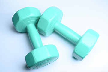 two green dumbbell on white background, object for exercise