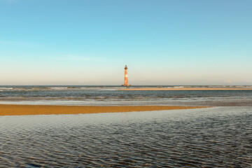 Morris Island Lighthouse from the shoreline of Folly Beach near Charleston, South Carolina.