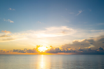 Sunset on tropical beach sea ocean with sunrise clouds. Banner for travel vacation. Scenery sky and...