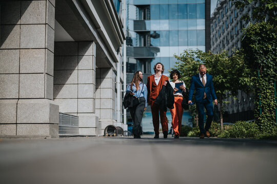 A group of business professionals walking and laughing together outside a modern office building, reflecting teamwork and corporate success. - Powered by Adobe